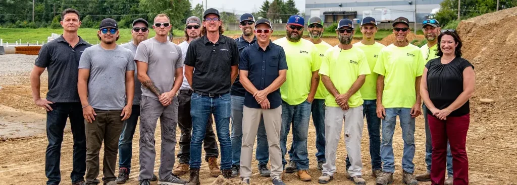 Construction crew group photo on job site.webp