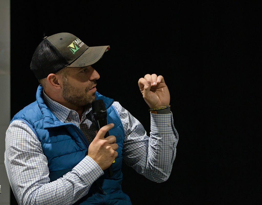 Cory Cochran speaking on stage at the McRae headquarters grand opening