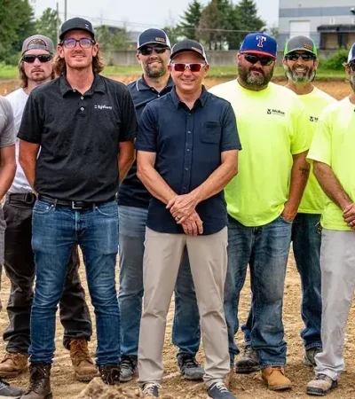 Construction crew group photo on job site.webp